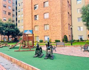 a park with a playground with a swing set at Flat en Av Granados in Quito