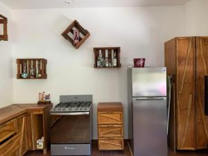 a kitchen with a refrigerator and a stove at The Jungle House, Sacbé in Playa del Carmen +12 photos