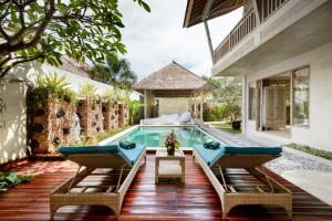 a swimming pool in the backyard of a house at Adinda Balangan Beach Villa in Jimbaran