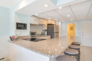 a kitchen with a counter and some stools in it at Patio and Pond View Serene Cape Cod Escape in Mashpee