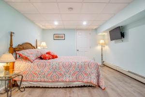 a bedroom with a bed and a flat screen tv at Patio and Pond View Serene Cape Cod Escape in Mashpee