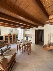a kitchen and dining room with a table and chairs at Affaccio sul Mare Attico in Tropea