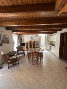 a kitchen and living room with a table and chairs at Affaccio sul Mare Attico in Tropea +17 photos