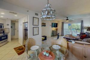 a kitchen and living room with a table and chairs at 105 - Caprice Resort in St. Pete Beach