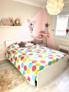 a bedroom with a bed with polka dot sheets at La Maison Nikaïa in Narbonne +7 photos