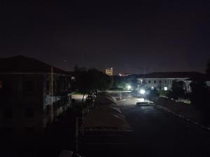 a city street at night with lights on at Sanctuary at Waterfall in Midrand