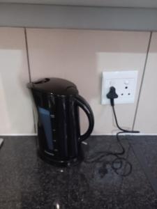 a black coffee cup sitting on a counter at Sanctuary at Waterfall in Midrand
