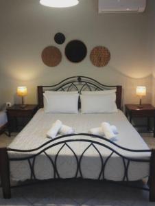 a bedroom with a bed with two towels on it at Cleopatra's Cozy Cottage in Keramoti