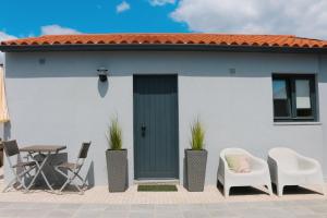 a house with a green door and chairs at 9min Metro to Downtown - couples&kids - free parking in Porto