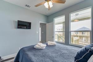 a bedroom with a bed and a ceiling fan at By The Sea by Bolivar Escapes in Port Bolivar