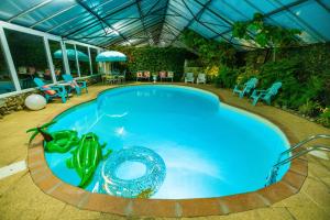 a swimming pool in a house with aperature at Château de Montmireil in Canisy
