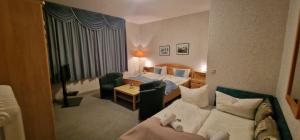 a hotel room with a bed and a couch at Hotel-Restaurant Wilhelmsbad in Seesen +97 photos