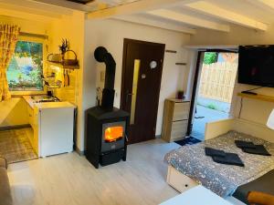 a living room with a stove in a room at Noclegi u Justyny in Łagów