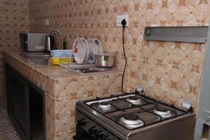 a kitchen with a stove and a counter top at Reliable Cosy Apartment 1 in Trofwi