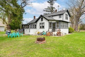 a white house with tables and chairs in the yard at Twin Lakes Cottage Walk to Elizabeth Lake! in Twin Lakes