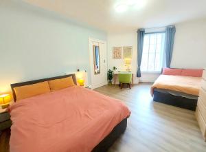 a bedroom with two beds and a desk in it at Spacious Victorian Apartment in Edinburgh City in Edinburgh