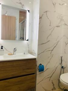 a bathroom with a sink and a mirror at Lotus Bay Retreat in Agadir +11 photos