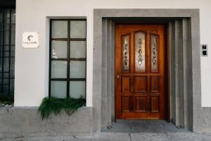 a wooden door on a building with two windows at Casa Castillo Condesa in Mexico City +12 photos