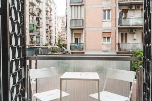 two chairs and a table on a balcony with buildings at Monteverde Vatican in Rome