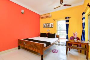 Postel nebo postele na pokoji v ubytování Hotel O Aradhya Beach Resort