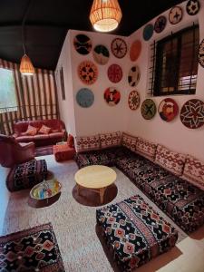 a living room with a couch and a table at moroccan traditional equipped apartment in Marrakech