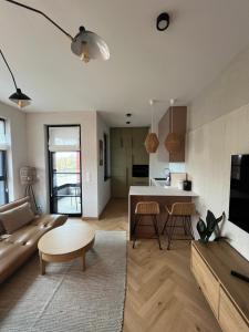 a living room with a couch and a table at WIDOKI3 Apartment Montownia Foodhall in Gdańsk