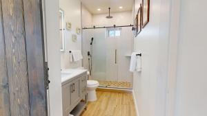 a white bathroom with a toilet and a shower at The Beach House in Ocean City