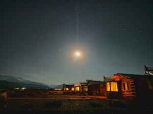 a night sky with the moon over a cabin at Cabañas Tierra Adentro in Uspallata