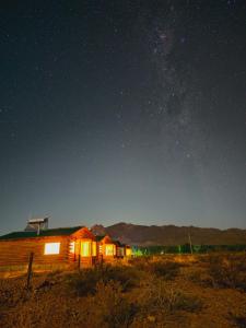 a house in the middle of a field at night at Cabañas Tierra Adentro in Uspallata