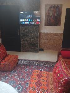 a room with two chairs and a fireplace and a door at moroccan traditional equipped apartment in Marrakech