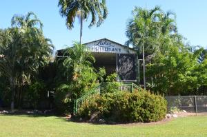 a building with palm trees in a park at AAOK Lakes Resort and Caravan Park in Berry Springs