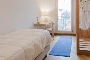a bedroom with a bed and a desk and a window at La casa di rovere in Lugo