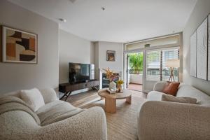 a living room with two couches and a television at Promo Casa Miel Heart of Westwood Luxury Condo in Los Angeles