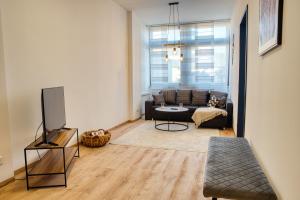 a living room with a couch and a tv at TheFamilyNest in Amberg