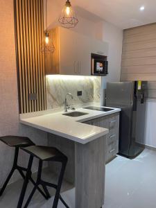 a kitchen with a sink and a refrigerator at Luxury Park 35 in Cali
