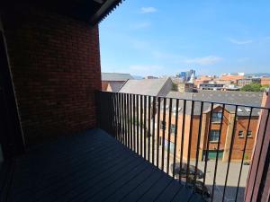 a balcony with a view of a brick building at 2 BR City Centre Apartment with Terrace in Belfast +9 photos
