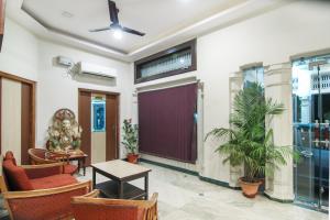 a lobby with chairs and a door and a table at Hotel O Lukergunj Holidays in Muthiganj