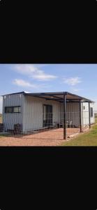 a large white building with a fence around it at Las andinas in Carmelo