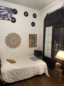 a bedroom with a bed and records on the wall at Republica Hostel in San Pedro