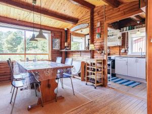 a kitchen with a table and chairs in a cabin at 6 person holiday home in Ålbæk-By Traum in Ålbæk