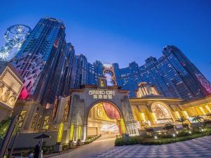a shopping mall with tall buildings in the background at Studio City Hotel in Macau