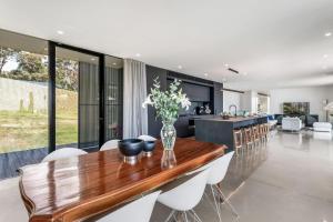 a kitchen and dining room with a wooden table and chairs at Coolum Beach Country Retreat in Yandina Creek