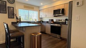 a kitchen with stainless steel appliances and a counter at Homestead Village - Two Bedroom Condo Balcony in Sandpoint