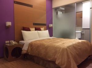 Voodi või voodid majutusasutuse 紫園旅社Purple Garden Hotel toas