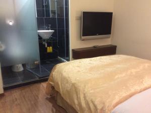 Voodi või voodid majutusasutuse 紫園旅社Purple Garden Hotel toas