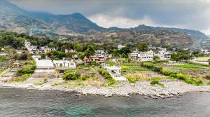 an aerial view of a town next to the water at Casa del Abuelo in San Pedro La Laguna