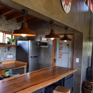 a kitchen with a refrigerator and two pendant lights at Claro de Luna in Villa Yacanto