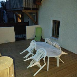 a table and four chairs on a deck at House 20 minutes from Geneva & beaches in Saint-Cergues