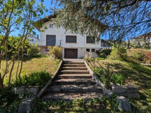 a house on a hill with stairs in front at Maison à Gérardmer avec vue sur montagnes, garage et jardin - FR-1-589-776 in Gérardmer