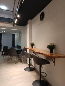a conference room with a wooden table and chairs at Loft of e-smile in Thessaloniki